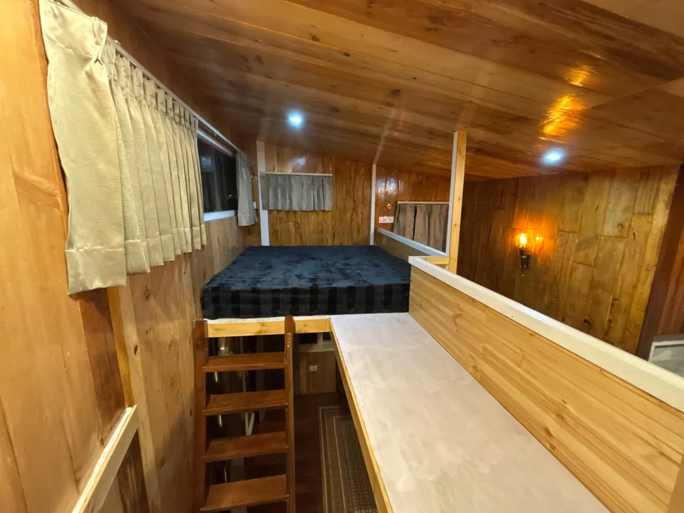 Loft sleeping area inside the wooden cabin