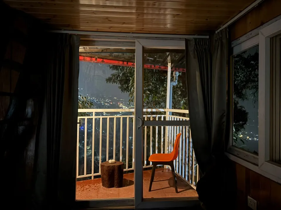 Cabin balcony and town lights at night